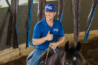 Michael Gascon actively working on a horse in an arena, demonstrating training techniques and skill development in a controlled environment.