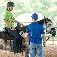 Michael Gascon providing instruction and guidance while teaching a client during a Gascon horsemanship clinic.