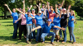 Michael Gascon posing with a group of clients during a Horse Help retreat, fostering community and learning in an equestrian setting.