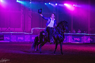 Image of Michael Gascon delivering an impactful performance during the Gascon Horsemanship Never Give Up Tour, showcasing his expertise, connection with the horse, and captivating the audience with dynamic equestrian skills.
