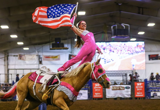 Image of Kelsey Gascon performing during a Trixie Chicks Riders performance, showcasing extraordinary equestrian skills and thrilling tricks.