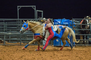 Image of Kelsey Gascon performing during a Trixie Chicks Riders performance, showcasing extraordinary equestrian skills and thrilling tricks.
