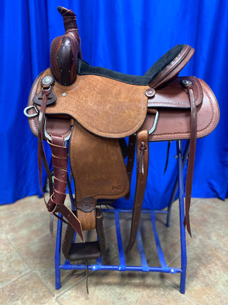 An image featuring an MG custom saddle equipped with a roping horn, designed for roping activities and western riding disciplines.