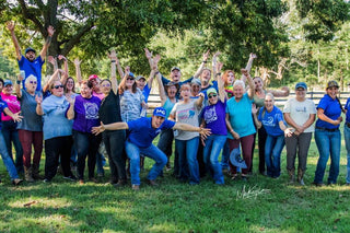 Michael Gascon posing with a group of clients during a Horse Help retreat, fostering community and learning in an equestrian setting.