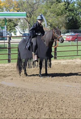 Image of a horse rider and horse in their Halloween costume, featuring the vibrant orange MG halter, showcasing festive and creative equestrian attire for the occasion.