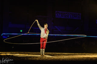 Image of Dalton Morris captivating the audience with his impressive Trick Roping Act during the Gascon Horsemanship Never Give Up Tour, showcasing skill and precision in the art of trick roping.