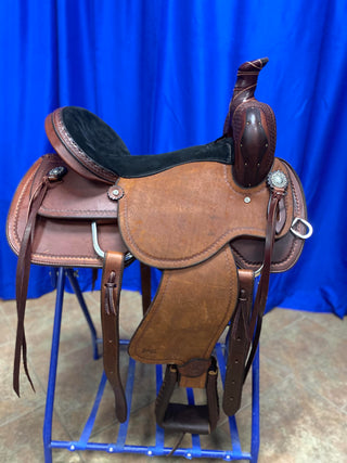 An image featuring an MG custom saddle equipped with a roping horn, designed for roping activities and western riding disciplines.