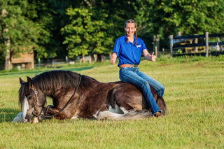 Dedicated intern posing proudly with their horse, showcasing a positive learning experience and a strong bond between the intern and the equine partner.