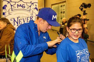 Image of Michael Gascon during the Gascon Horsemanship Never Give Up Tour, engaging in autograph signing, capturing a moment of connection and appreciation with attendees and fans.