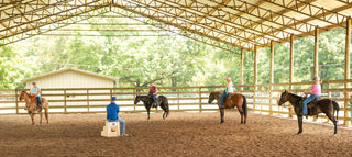 Michael Gascon guiding retreat participants and their horses in the arena, fostering a collaborative and educational equestrian experience.