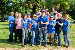 Michael Gascon posing with a group of clients during a Horse Help retreat, fostering community and learning in an equestrian setting.