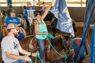 Image of retreat participants actively working on their horses in the arena, fostering a collaborative and hands-on learning environment during the retreat.