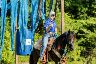 Image of a Horse Help Train-Off contestant confidently navigating through the obstacle course, demonstrating skill and determination.