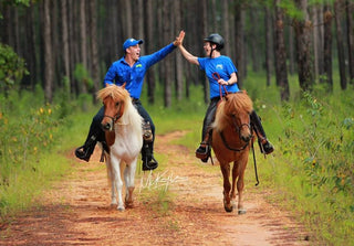 Michael Gascon and a customer enjoying a trail ride together with their horses, creating a positive and memorable equestrian experience.