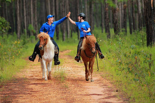 Michael Gascon and a customer enjoying a trail ride together with their horses, creating a positive and memorable equestrian experience.