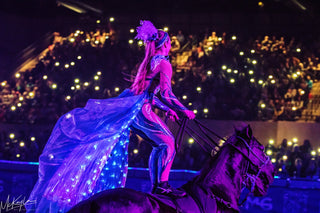 Image of Kelsey Gascon gracefully performing the Roman Riding Act during the Gascon Horsemanship Never Give Up Tour, showcasing synchronized horsemanship skills and creating a visually stunning and dynamic equestrian spectacle.
