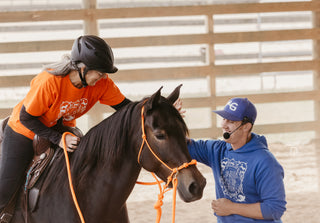 Michael Gascon providing personalized instruction to a customer during a retreat, fostering a positive learning environment and enhancing the equestrian experience.