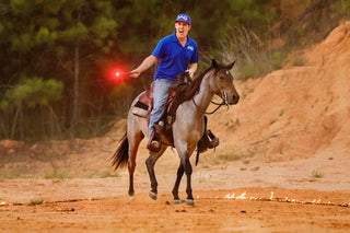Image of Michael Gascon and his horse, both calm and unperturbed, showcasing composure and trust even in the presence of fireworks and fire.