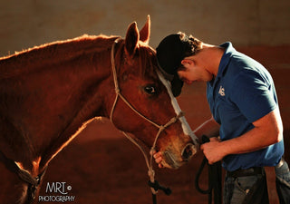 Michael Gascon demonstrating genuine affection to a horse, capturing a heartfelt moment of connection between the equestrian and the equine companion.