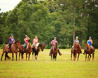 Michael Gascon posing with a group of clients during a Horse Help retreat, fostering community and learning in an equestrian setting.