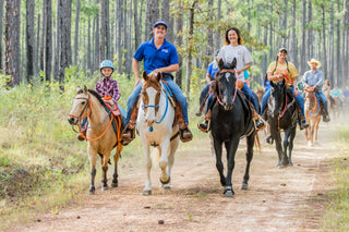 Michael Gascon leading a group of clients on a scenic trail ride, fostering camaraderie and enjoying the equestrian experience together.