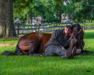 Michael Gascon posing gracefully with a horse, showcasing a harmonious connection and the bond between the equestrian and the equine partner.