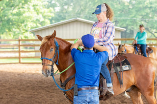 Michael Gascon providing personalized instruction to a customer during a retreat, fostering a positive learning environment and enhancing the equestrian experience.