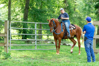 Michael Gascon providing personalized instruction to a customer during a retreat, fostering a positive learning environment and enhancing the equestrian experience.