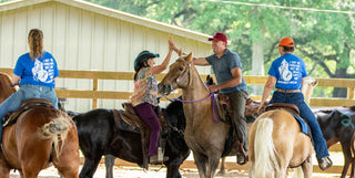 Image of retreat participants actively working on their horses in the arena, fostering a collaborative and hands-on learning environment during the retreat.