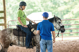 Michael Gascon providing instruction and guidance while teaching a client during a Gascon horsemanship clinic.