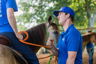 Michael Gascon providing personalized instruction to a customer during a retreat, fostering a positive learning environment and enhancing the equestrian experience.