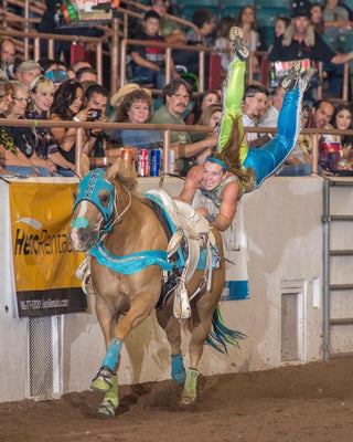 Image of Kelsey Gascon performing during a Trixie Chicks Riders performance, showcasing extraordinary equestrian skills and thrilling tricks.