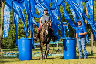 Michael Gascon guiding his student through equestrian obstacles, emphasizing skill development and partnership.
