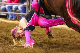 Image of Shelby Epperson performing during a Trixie Chicks Riders performance, showcasing extraordinary equestrian skills and thrilling tricks.