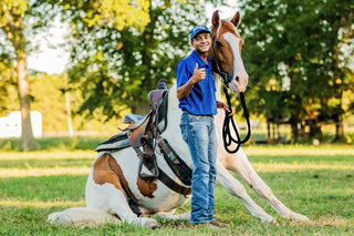 An aspiring horse trainer posing confidently with their equine partner. Capturing the spirit and dedication of a budding equestrian on their journey towards expertise.