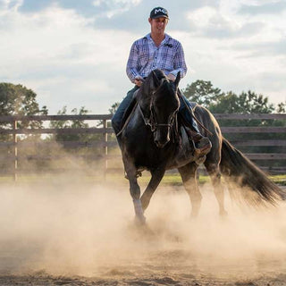Michael Gascon actively working on a horse in an arena, demonstrating training techniques and skill development in a controlled environment.