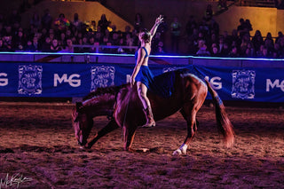 Image of Cat Zimmerman showcasing her impressive Mustang Liberty Act during the Gascon Horsemanship Never Give Up Tour, demonstrating a strong bond and harmony between her and the Mustang, captivating the audience with their performance.