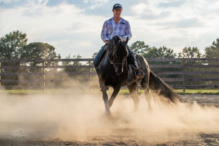 Michael Gascon skillfully riding a horse in an arena, demonstrating expert horsemanship and control.