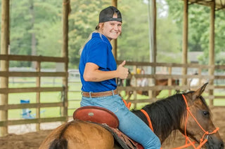 A Horse Help Train-Off contestant striking a pose with her horse, showcasing the bond and teamwork cultivated through the training program.