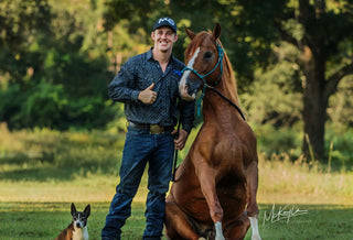 Michael Gascon posing with his horse and dog, showcasing a heartwarming connection between the equestrian, equine, and canine companions.