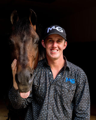 Michael Gascon posing gracefully with a horse, showcasing a harmonious connection and the bond between the equestrian and the equine partner.
