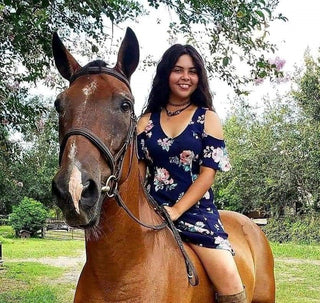 A Horse Help Train-Off contestant striking a pose with her horse, showcasing the bond and teamwork cultivated through the training program.