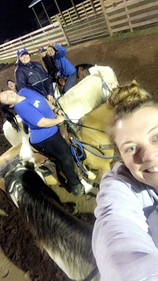 Image of Kelsey and Michael Gascon posing with the Gascon Horsemanship staff, showcasing the collaborative and unified team spirit within Gascon Horsemanship.
