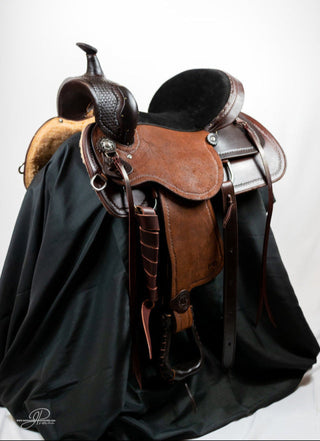 An image featuring an MG custom saddle equipped with a roping horn, designed for roping activities and western riding disciplines.