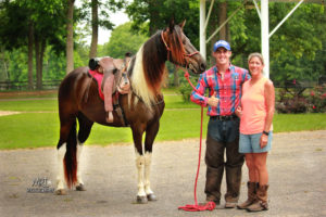 Michael Gascon posing with a satisfied customer and her horse, capturing a moment of connection and achievement during a Gascon Horsemanship session.