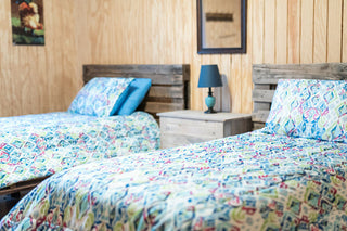 Cozy 2-bed bedroom in the Horse Haven Hotel, adorned with western-inspired decor, creating a comfortable and rustic ambiance for guests.