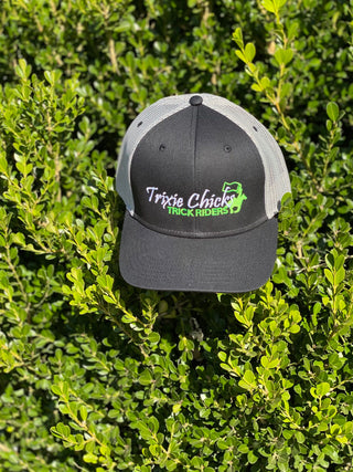 A black Trixie Chicks Trick Riders cap with grey accents, featuring a stylish design and vibrant colors, ideal for trick riding enthusiasts