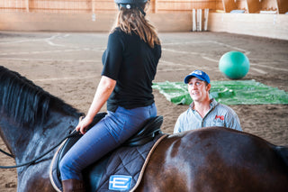 Michael Gascon providing personalized instruction to a customer during a retreat, fostering a positive learning environment and enhancing the equestrian experience.