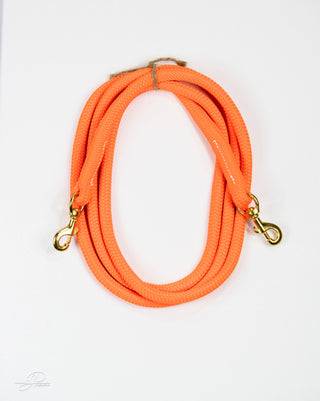 Orange MG reins, essential horse tack for communication and control while riding.