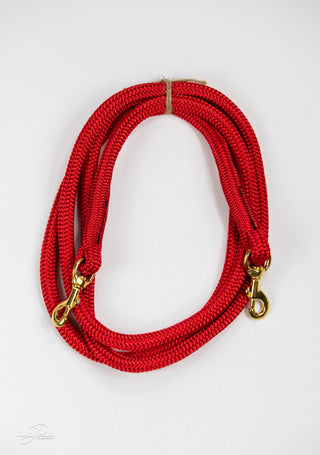 Red MG reins, essential horse tack for communication and control while riding.